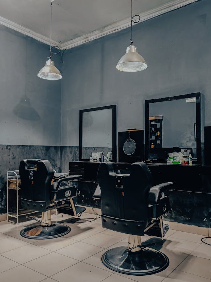 Mastering the First Impression: Your intriguing post title goes here Cozy vintage-style barbershop interior in Indonesia with empty barber chairs and mirrors.